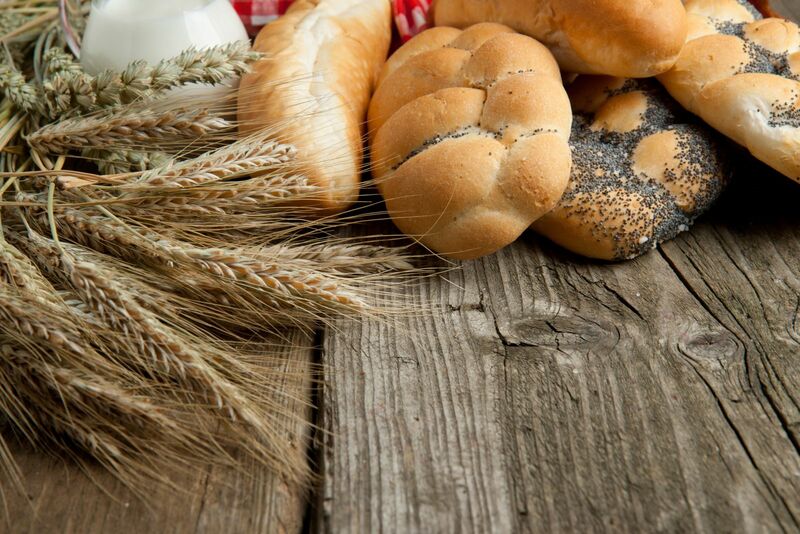 Wheat and bread on table